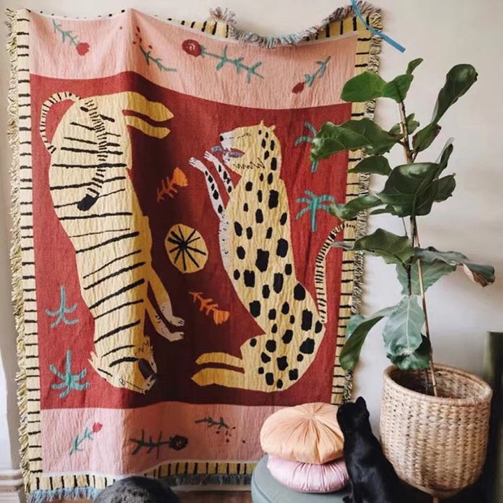 VibeCore Feline Power Woven Blanket with bold jungle feline design, 100% combed cotton, reversible patterns, and versatile use as a throw, wall hanging, rug, or tablecloth.