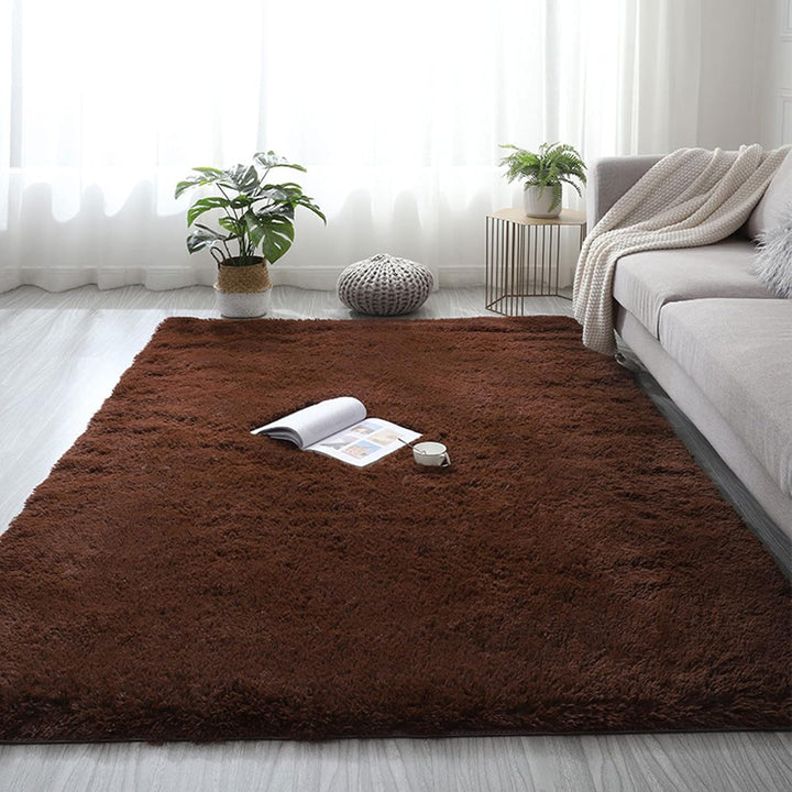 The VibeCore Fluffy Area Rug in Brown placed in a cozy living room, adding warmth and texture to the space with its soft, plush feel and earthy tone.