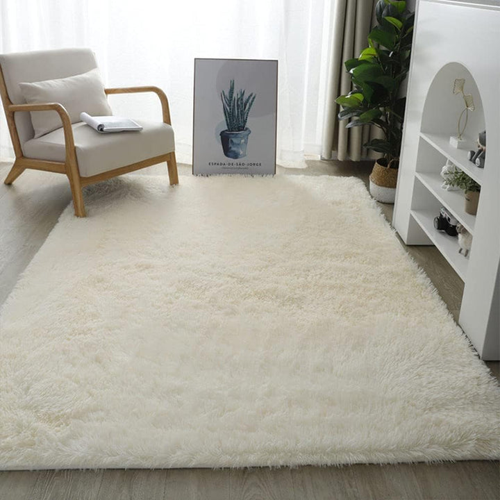 VibeCore Fluffy Area Rug in Cream placed on the floor, adding warmth and a soft, inviting touch to the room's decor with its plush texture.