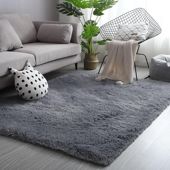 VibeCore Fluffy Area Rug in Gray, placed in a living room, showcasing its plush texture and neutral color, adding comfort and style to the space.