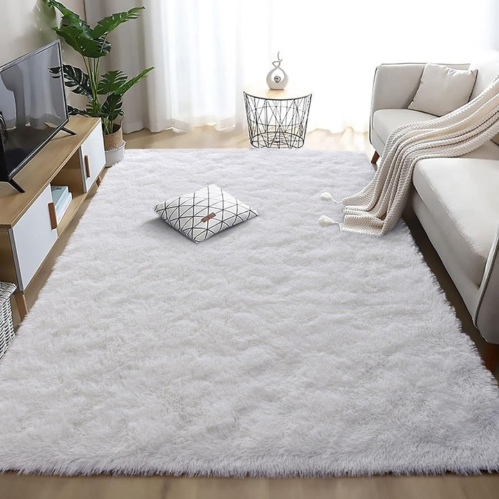 VibeCore Fluffy Area Rug in White placed in a living room, creating a cozy and inviting atmosphere. The soft texture enhances the room's comfort, complementing modern and minimalist decor.