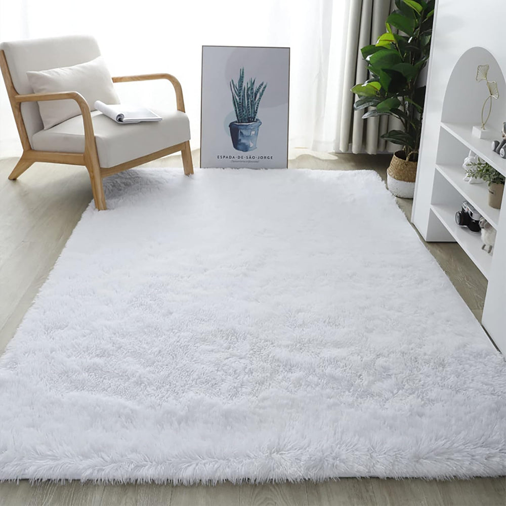 VibeCore Fluffy Area Rug in White on the floor, showcasing its plush texture that adds warmth and comfort to the space. Perfect for enhancing the aesthetic of living rooms, bedrooms, or any room that needs a soft, inviting touch.
