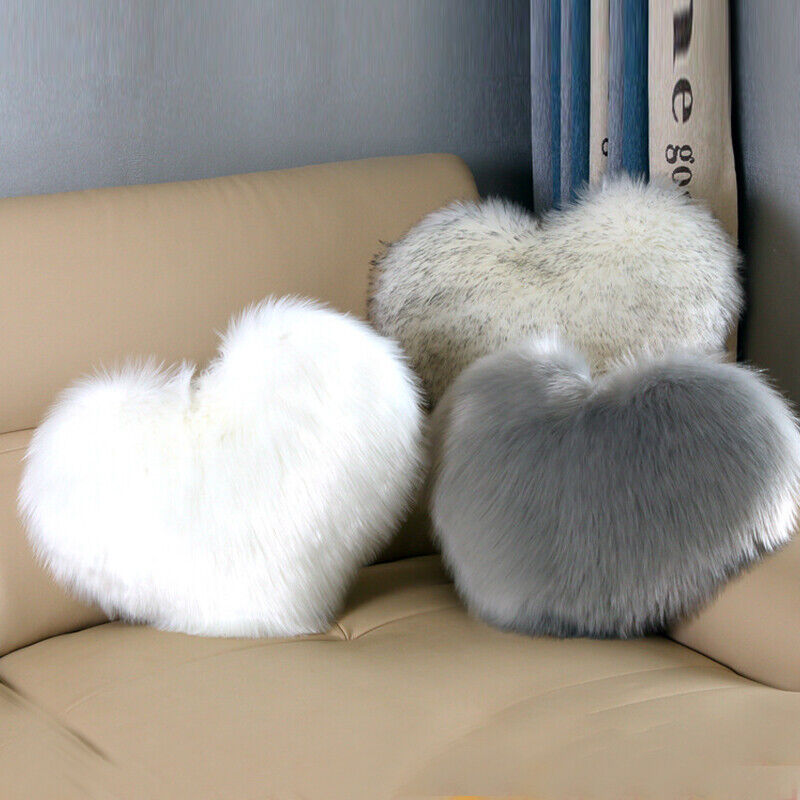 VibeCore Fluffy Heart Throw Pillow in 3 colors on couch - soft faux fur, heart-shaped design, perfect for adding cozy, romantic, and aesthetic vibes to living rooms or bedrooms.