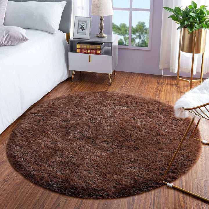 VibeCore Fluffy Round Area Rug in brown beside the bed, featuring a soft plush texture and non-slip backing. Cozy and stylish, perfect for adding warmth and comfort to any bedroom. Easy to clean and available in 8 colors.