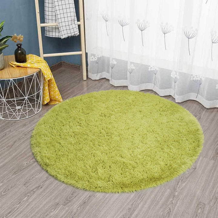 VibeCore Fluffy Round Area Rug in green on the floor, featuring a soft plush texture and non-slip backing. Cozy and stylish, perfect for bedrooms, living rooms, or dorms. Easy to clean and available in 8 colors.