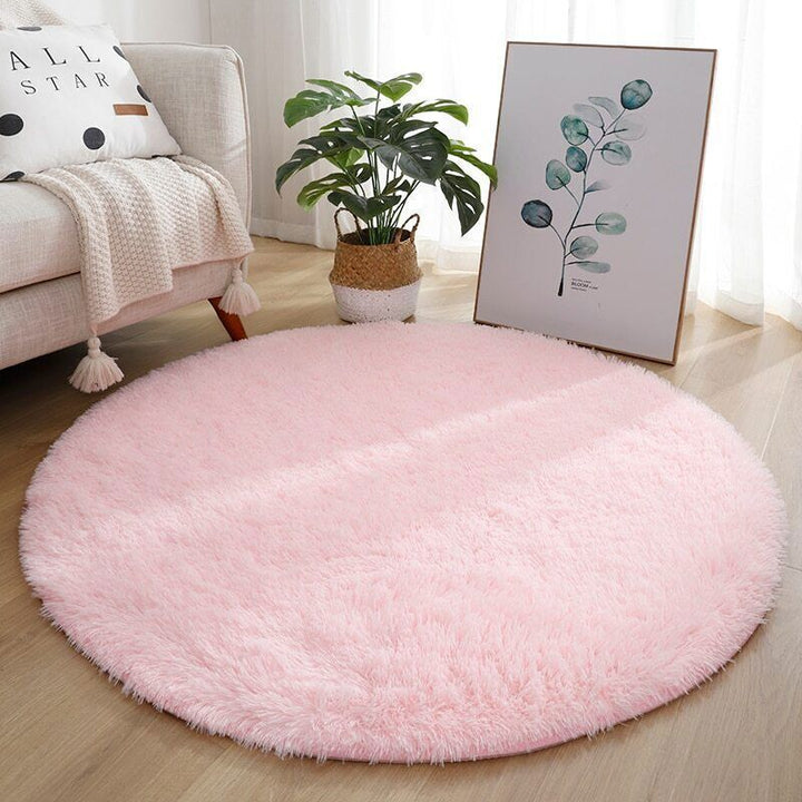 VibeCore Fluffy Round Area Rug in pink placed in a living room, featuring a soft plush texture and non-slip backing. Cozy and stylish, perfect for adding comfort to any space. Easy to clean and available in 8 colors.