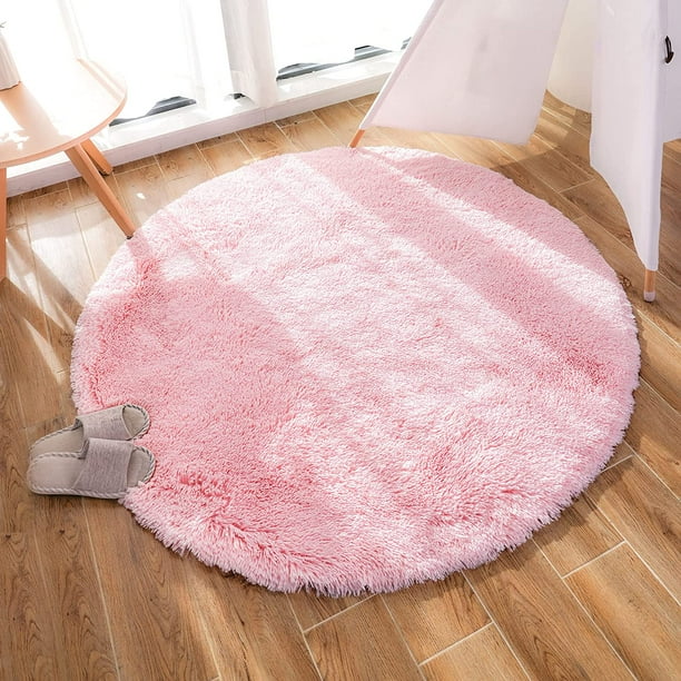 VibeCore Fluffy Round Area Rug in pink on the floor, featuring a soft plush texture and non-slip backing. Cozy and stylish, perfect for bedrooms, living rooms, or dorms. Easy to clean and available in 8 colors.