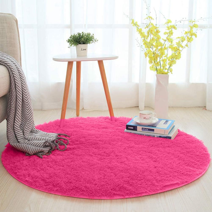VibeCore Fluffy Round Area Rug in rose red on the floor, featuring a soft plush texture and non-slip backing. Cozy and stylish, perfect for bedrooms, living rooms, or dorms. Easy to clean and available in 8 colors.