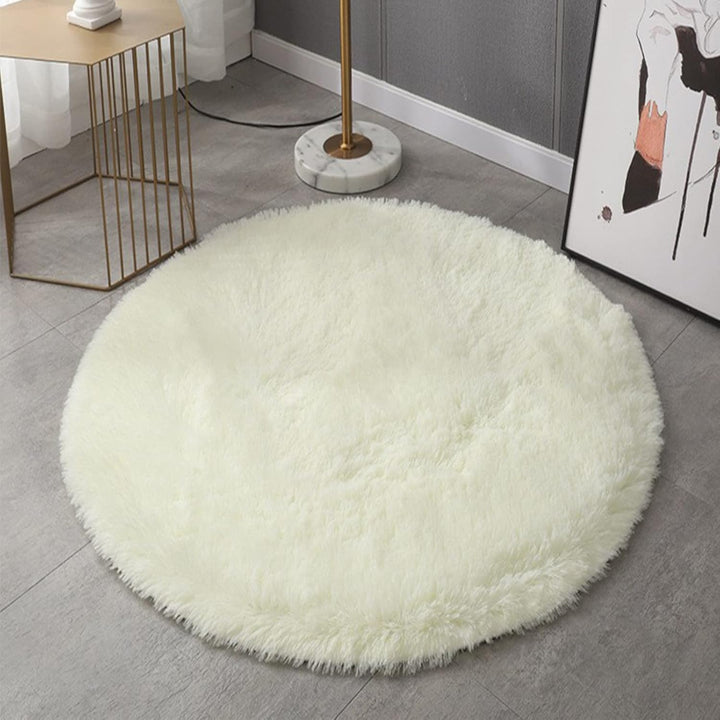 VibeCore Fluffy Round Area Rug in white on the floor, featuring a soft plush texture and non-slip backing. Cozy and stylish, perfect for bedrooms, living rooms, or dorms. Easy to clean and available in 8 colors.