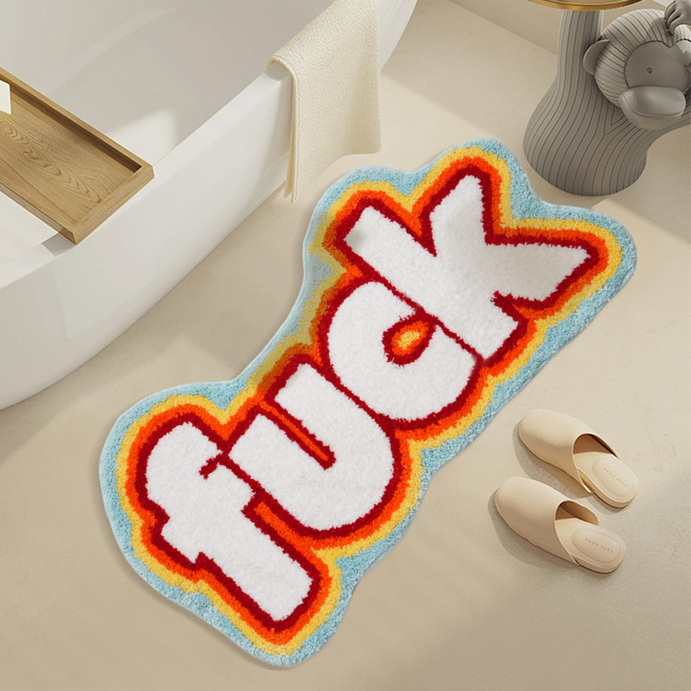 VibeCore Fuck Accent Rug placed in front of a tub, showcasing its bold and rebellious design. The non-slip backing ensures safety, while its soft texture adds comfort and style to the bathroom. Perfect for those who want to make a statement with their decor.