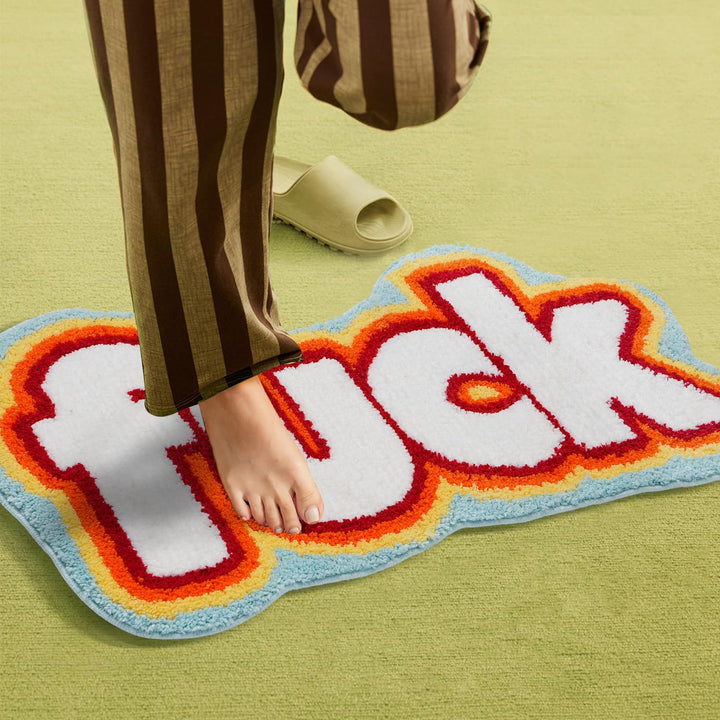 VibeCore Fuck Accent Rug with a person standing on it, highlighting the bold design and soft, fluffy texture. The non-slip backing ensures it stays securely in place, adding a rebellious touch and comfort to any space.