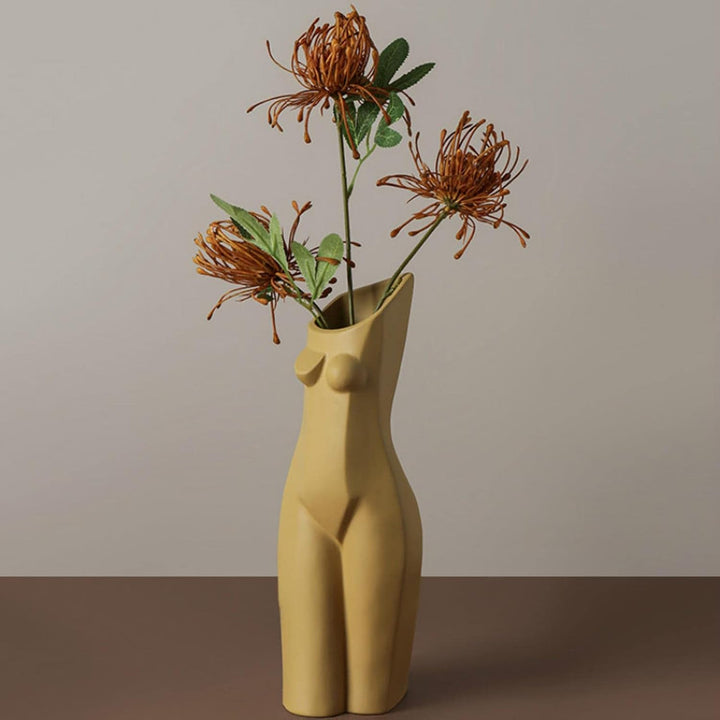 VibeCore Geometric Female Body Vase Khaki with flowers in it, featuring a sculpted female figure design with organic curves, holding fresh blooms to complement its modern minimalist aesthetic.