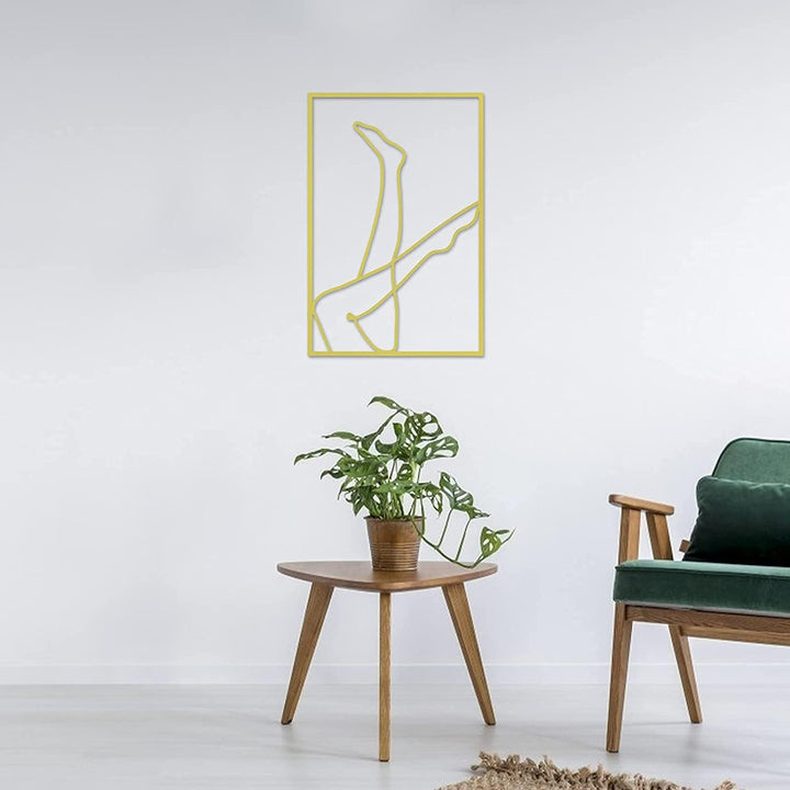 Gold female line art wall decor on living room wall – metallic gold acrylic silhouette of woman with legs in the air for modern living room, bedroom, or office – VibeCore minimalist aesthetic decor