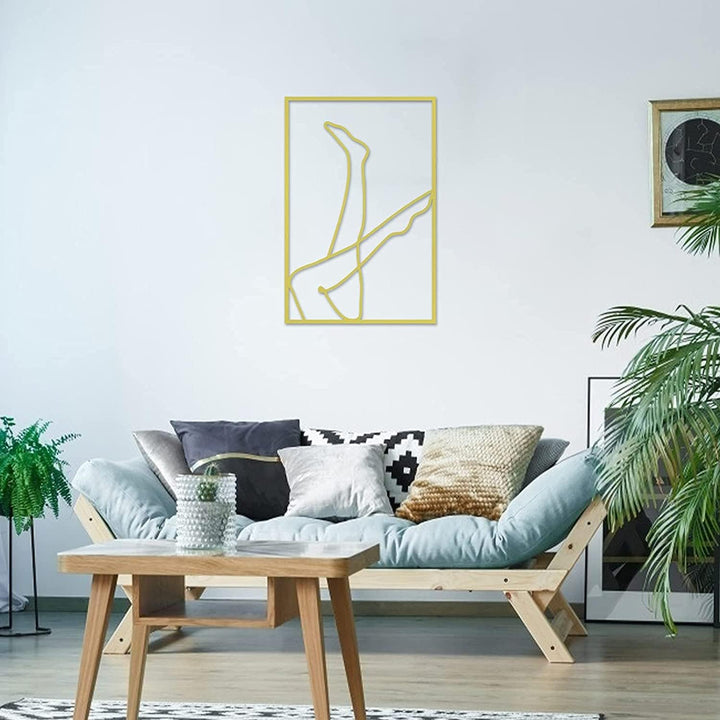 Gold female line art wall decor on wall – metallic gold acrylic silhouette of woman with legs in the air for modern bedroom, dorm room, or office – VibeCore minimalist aesthetic decor