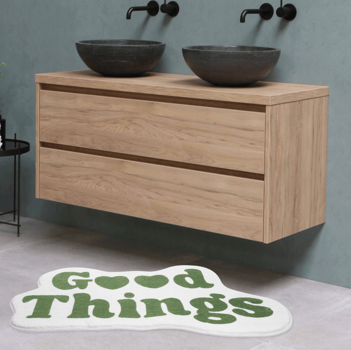 Aesthetic green "Good Things Accent Rug" displayed on the floor of a bathroom, featuring a motivational Y2K message. The soft, plush texture and non-slip backing provide comfort and safety, while adding a refreshing touch of positivity to your bathroom decor.