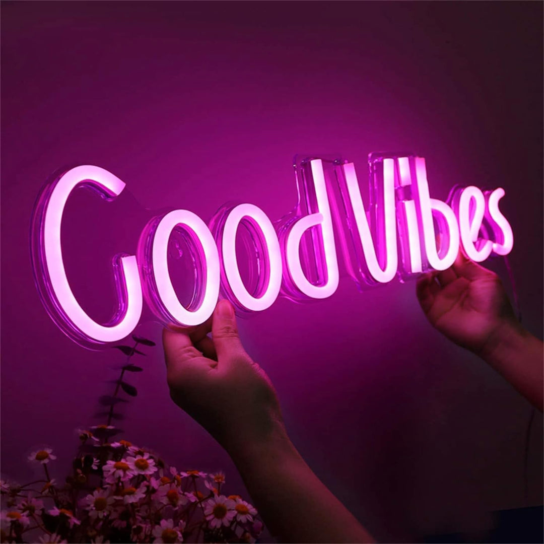 VibeCore Good Vibes Neon Light Pink Being Held Up