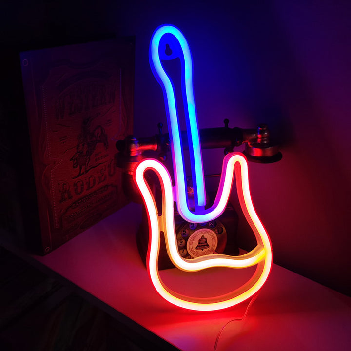 VibeCore Guitar Neon Light glowing next to a telephone, adding a vibrant and musical touch to the space.