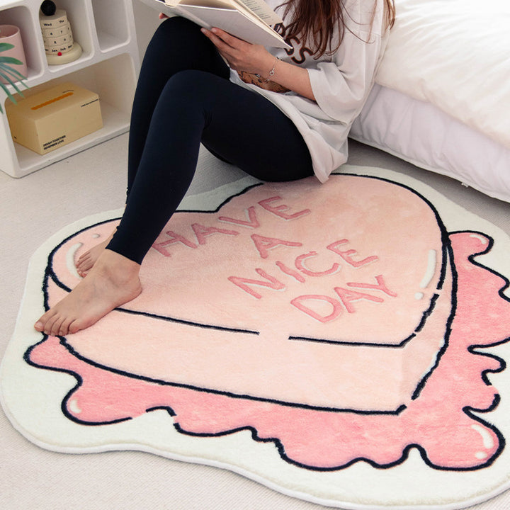 VibeCore Have A Nice Day Sweetheart Candy Accent Rug on floor with a girl sitting on it, highlighting the playful candy design and cheerful message in a relaxed setting.