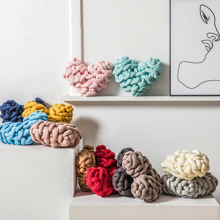 VibeCore Heart-Shaped Knot Throw Pillow in all colors, featuring a heart-shaped, woven knot design. Made from soft polyester fiber, this plush, cozy pillow adds a charming, stylish touch to your bed, couch, or cozy corner, creating a loving and inviting vibe in your space.