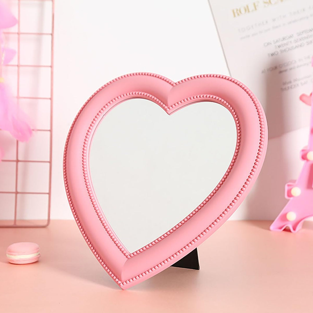 VibeCore Heart-Shaped Mirror in soft pink, displayed on a desk, adding a cute and trendy touch to the workspace with a modern aesthetic.