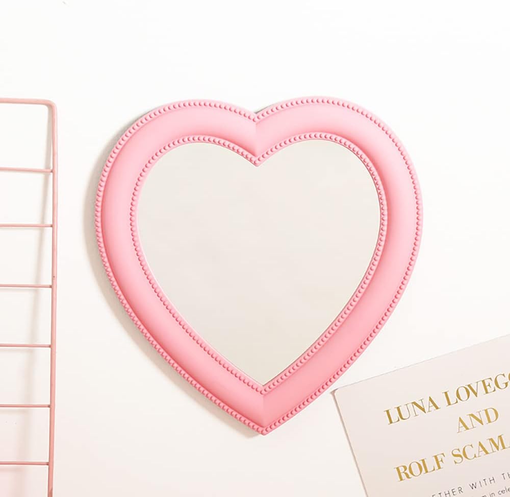 VibeCore Heart-Shaped Mirror in soft pink, hung on a wall, creating a charming and stylish accent in the room with a modern and cute vibe.