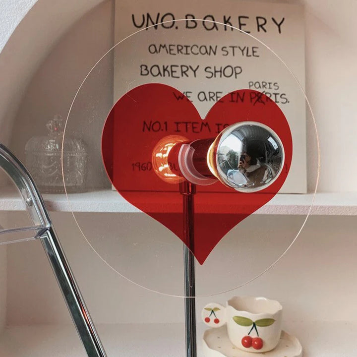 Close-up of VibeCore Heart Mood Lamp showing the detailed heart-shaped design on the plexiglass shade, glowing softly with a warm, cozy light.