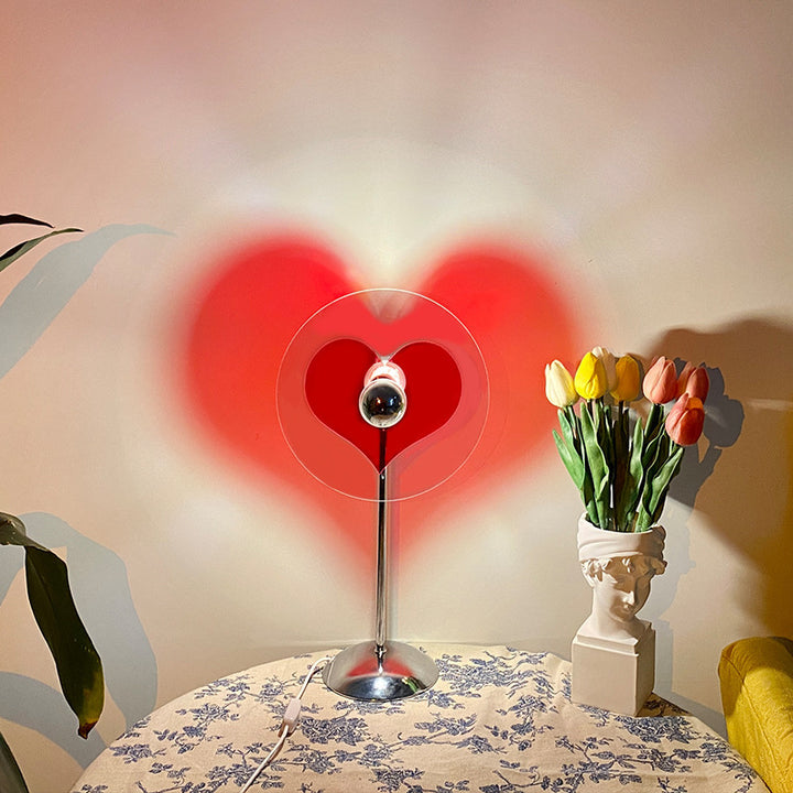 VibeCore Heart Mood Lamp on a table, casting a heart-shaped shadow and providing soft, warm lighting for a cozy and inviting atmosphere.