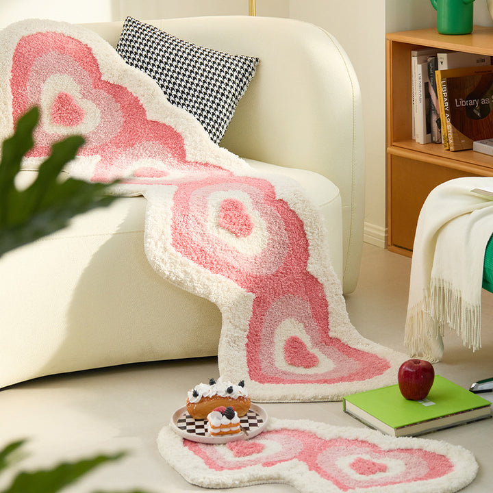 Aesthetic "Hearts Multiply Accent Rug" in large and small sizes, displayed in a living room. Featuring a playful pattern of multiplying hearts, this cute pink rug adds a sweet, cozy vibe while offering a soft, plush texture and non-slip backing for comfort and safety in high-traffic areas. Perfect for any room in your home.