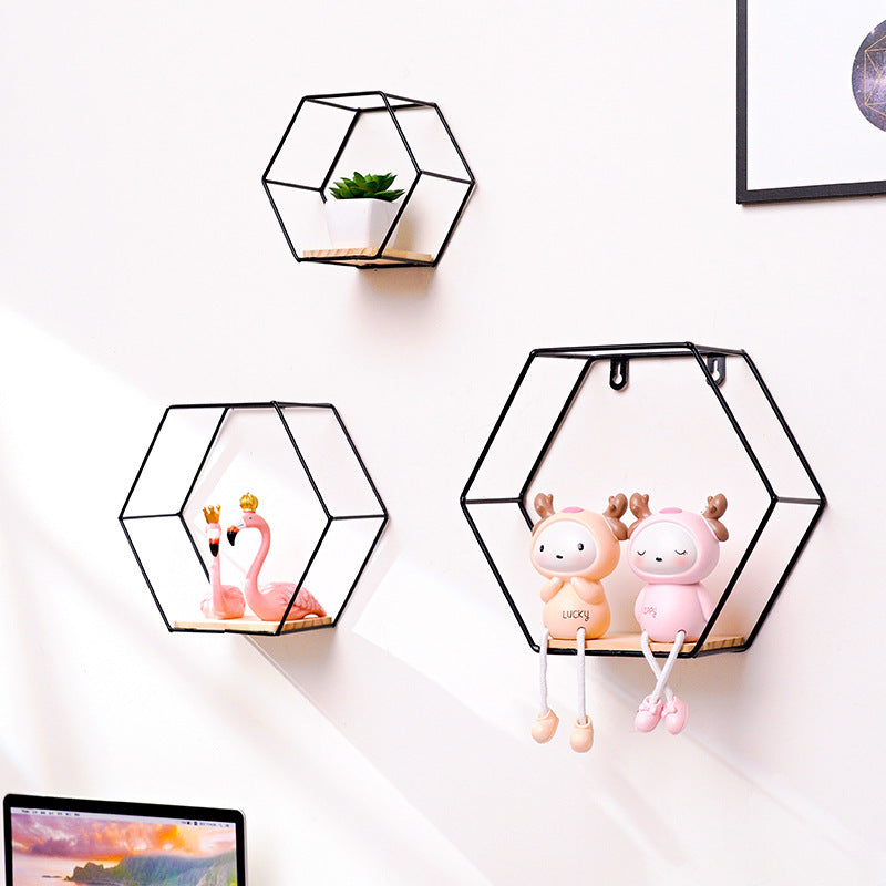 VibeCore Hexagonal Floating Wall Shelves in black, showcasing all three sizes on a wall, displaying various decor items like plants, frames, and candles.