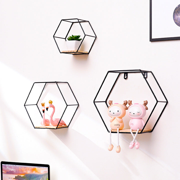 VibeCore Hexagonal Floating Wall Shelves in black, showcasing all three sizes on a wall, displaying various decor items like plants, frames, and candles.