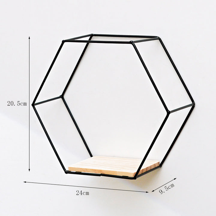 VibeCore Hexagonal Floating Wall Shelf in black, medium size, mounted on a wall with decorative items like books and small plants.