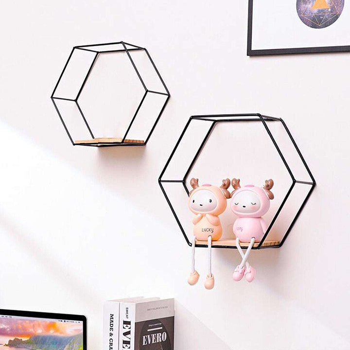 VibeCore Hexagonal Floating Wall Shelves in black, medium and large sizes, mounted on a wall with decorative items such as plants and books.