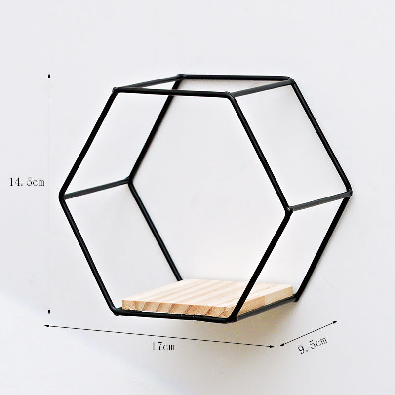 VibeCore Hexagonal Floating Wall Shelf in black, small size, mounted on a wall with decorative items such as plants and candles.