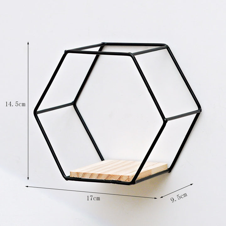 VibeCore Hexagonal Floating Wall Shelf in black, small size, mounted on a wall with decorative items such as plants and candles.