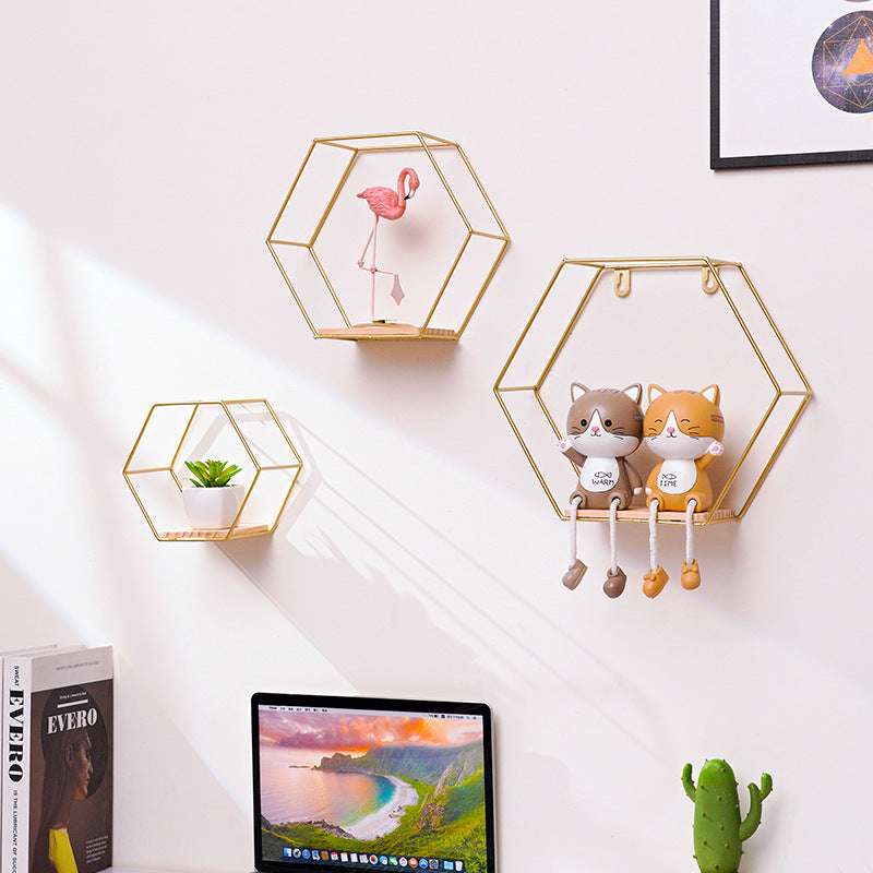 VibeCore Hexagonal Floating Wall Shelves in gold, showcasing all three sizes on a wall, displaying decorative items such as plants, candles, and framed photos.