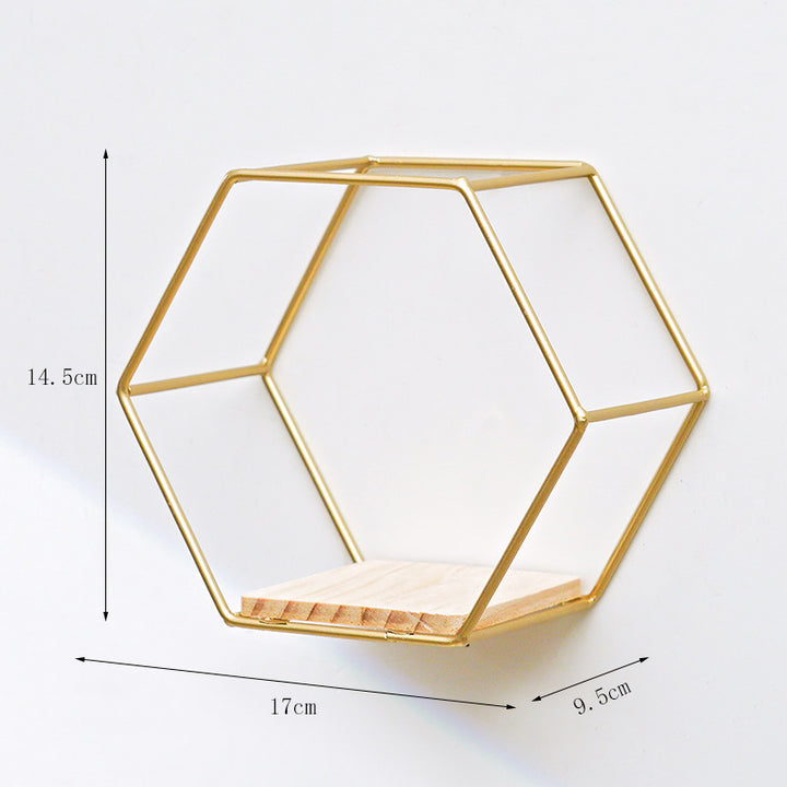 VibeCore Hexagonal Floating Wall Shelf in gold, medium size, mounted on a wall with stylish decor items like books and small plants.