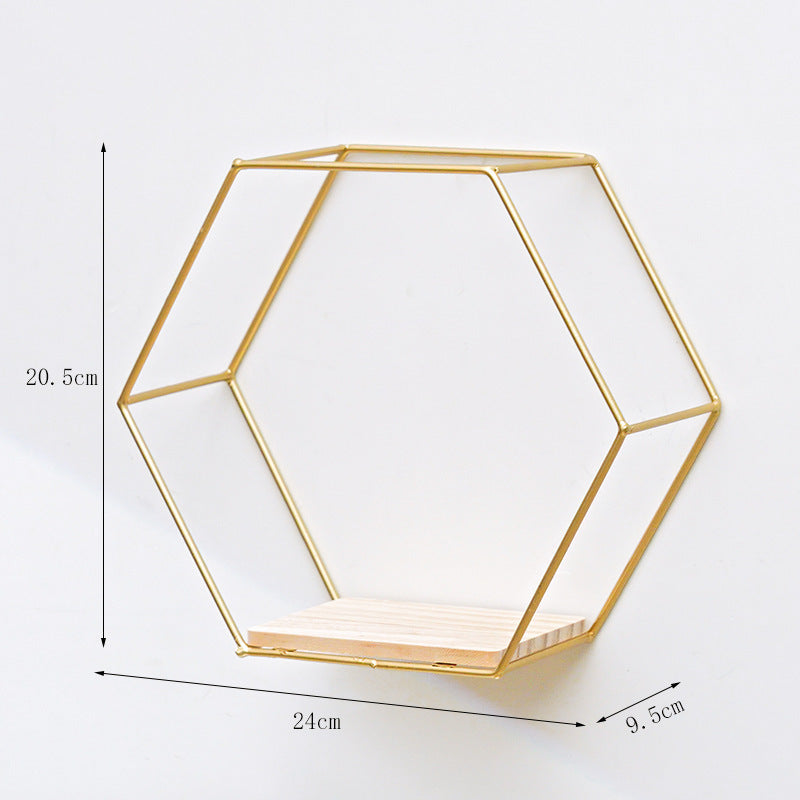 VibeCore Hexagonal Floating Wall Shelf in gold, small size, mounted on a wall with decorative plants and small trinkets displayed.