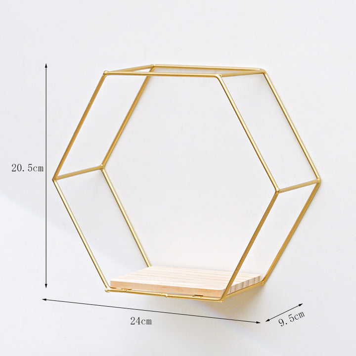 VibeCore Hexagonal Floating Wall Shelf in gold, small size, mounted on a wall with decorative plants and small trinkets displayed.