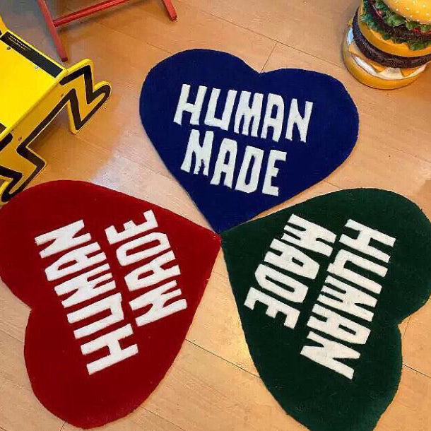 VibeCore Human Made Accent Rug in three vibrant colors—blue, red, and green—showcasing a striking heart design. The modern rug features a soft, plush texture, with an anti-slip backing for safety. Perfect for adding comfort and contemporary style to any room, from the living room to the bedroom.