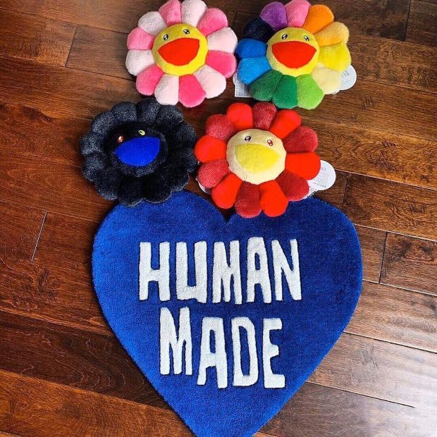 VibeCore Human Made Accent Rug in blue placed on the floor, showcasing its heart design and vibrant color. The rug adds a playful and stylish touch to the room while offering a soft and comfortable texture.