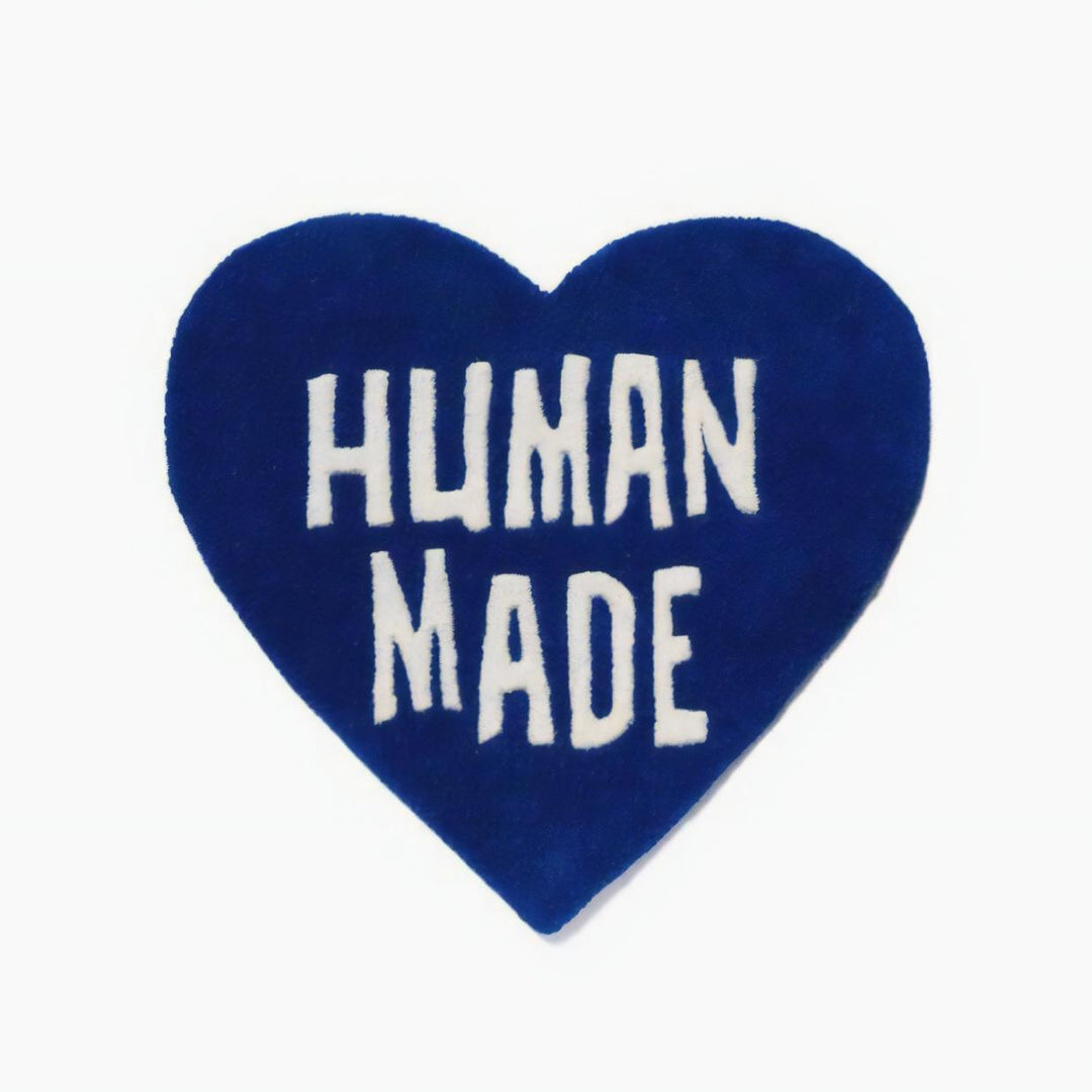 Product view of the VibeCore Human Made Accent Rug in blue, featuring a striking heart design and soft, plush texture. The non-slip backing is visible, ensuring safety and stability in any room.