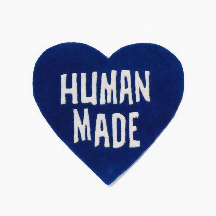 Product view of the VibeCore Human Made Accent Rug in blue, featuring a striking heart design and soft, plush texture. The non-slip backing is visible, ensuring safety and stability in any room.