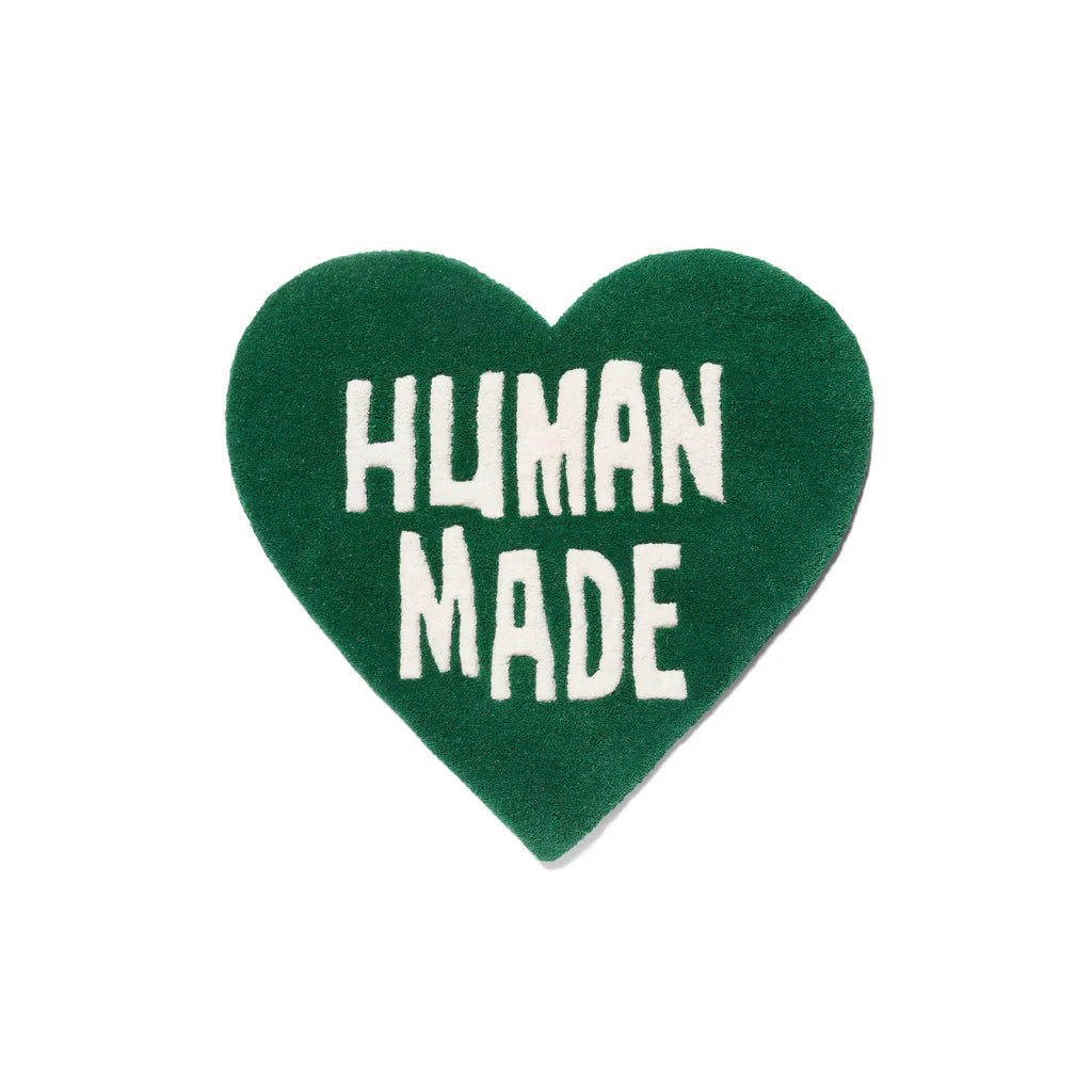 VibeCore Human Made Accent Rug in green, highlighting its heart-shaped design and modern message. The rug is displayed on the floor, adding a fresh, vibrant touch to any room while maintaining its soft, plush texture and non-slip backing.
