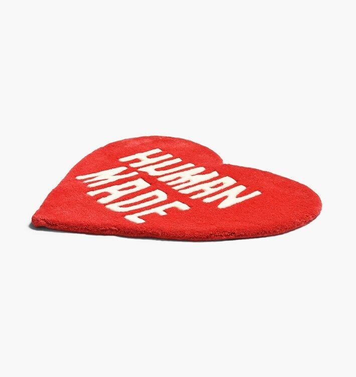 VibeCore Human Made Accent Rug in red with a heart design, shown at an angled view to highlight its vibrant color, soft texture, and non-slip backing. This modern rug adds personality and style to any room.