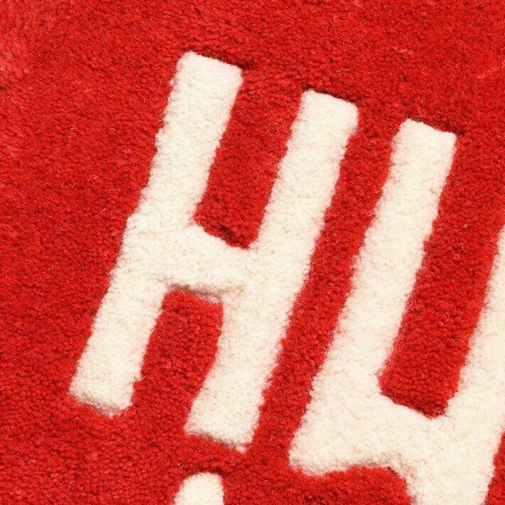 Close-up of the VibeCore Human Made Accent Rug in red, featuring a soft plush texture and bold heart design. The non-slip backing is visible, ensuring safety and stability.