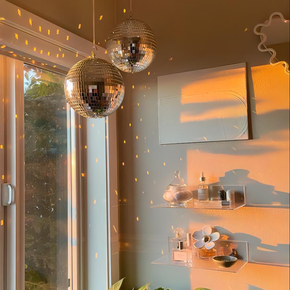 VibeCore Iconic Disco Ball hanging by a large window, reflecting light and casting shimmering reflections across the space, creating a lively and dynamic atmosphere.
