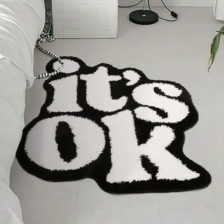 VibeCore It's Ok Accent Rug Alternative Aerial View: This sleek black and white rug features a simple yet impactful positive quote. Perfect for adding a calming, minimalist touch to any room. Its versatile design complements modern decor, making it ideal for bedrooms, living rooms, or dorms. The understated aesthetic brings peace and style to your space, creating a cozy and uplifting atmosphere.