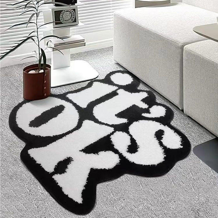 VibeCore It's Ok Accent Rug Side View: This minimalist rug showcases the iconic black and white 'It's Ok' quote in a simple yet stylish design. Perfect for a calming ambiance, it fits seamlessly into any bedroom, dorm, or living room. The side view highlights its sleek edges and plush texture, adding both comfort and positive vibes to your space.