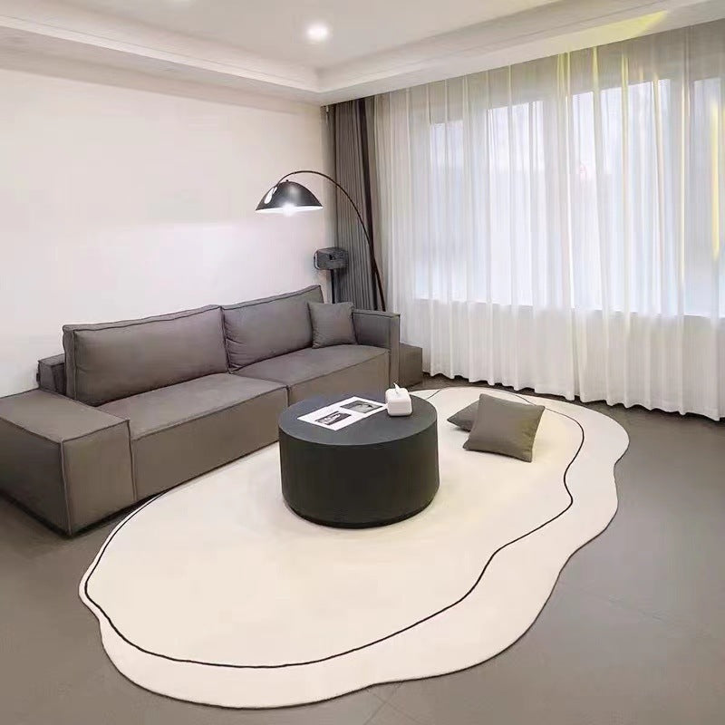 VibeCore Ivory Abstract Oval Area Rug in apartment living room, highlighting its timeless elegance and soft, neutral tones that elevate the space with a refined, cozy feel.