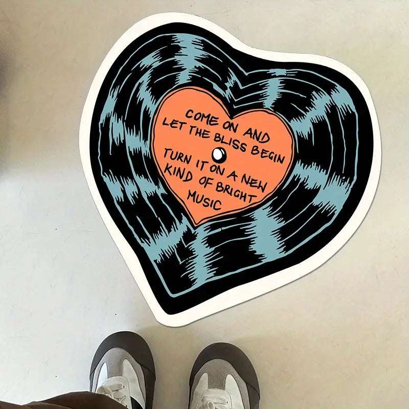 VibeCore "Let The Bliss Begin Accent Rug" on the floor beside feet, featuring a cozy cartoon heart design, bringing a warm, inviting vibe to the space.